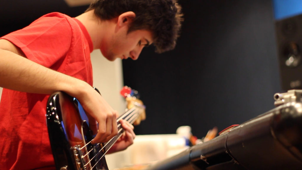 Man in red shirt playing guitar