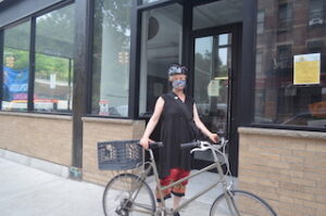 East Village biker dons a helmet before riding.