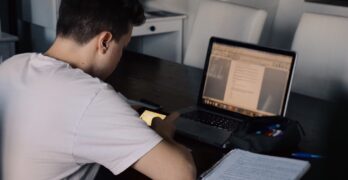 young-man-using-mobile-phone-while-studying-online-classes-e-learning-remote-classes-distant_t20_jXYdOk