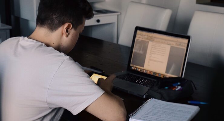 young-man-using-mobile-phone-while-studying-online-classes-e-learning-remote-classes-distant_t20_jXYdOk