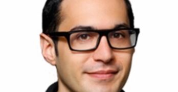 Picture of Eric Kohn -- a white man with rectangular-framed glasses -- above IndieWire's logo
