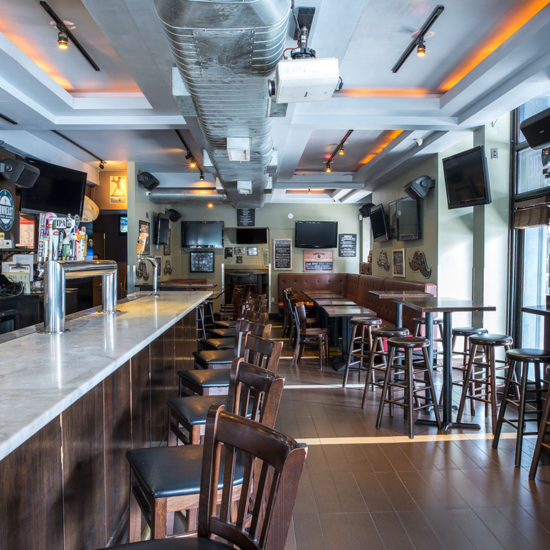 interior of Blue Haven's West Village location, light streaming through the windows. The bar is empty.