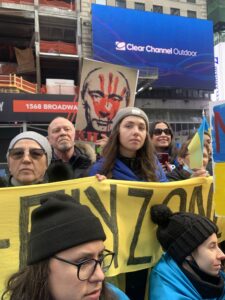 A group of protesters hold a no-fly zone banner