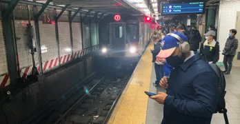 Riders wait at a subway station