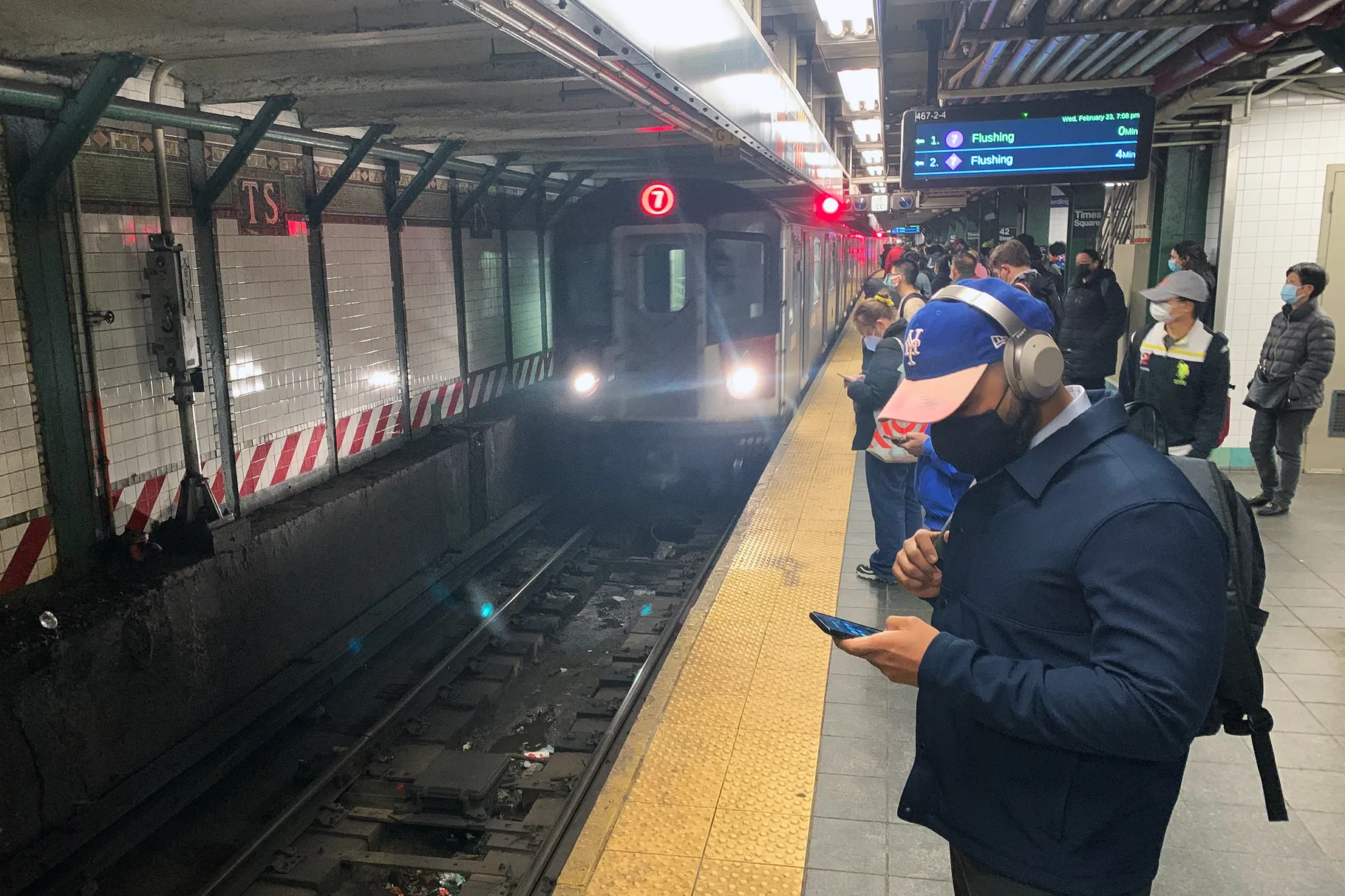 Riders wait at a subway station