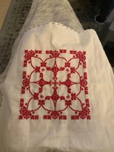 Finished red needlework with floral patterns