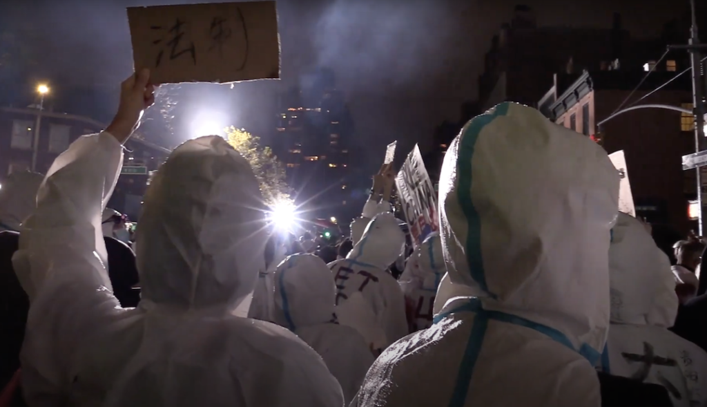 Chinese protesters holding signs