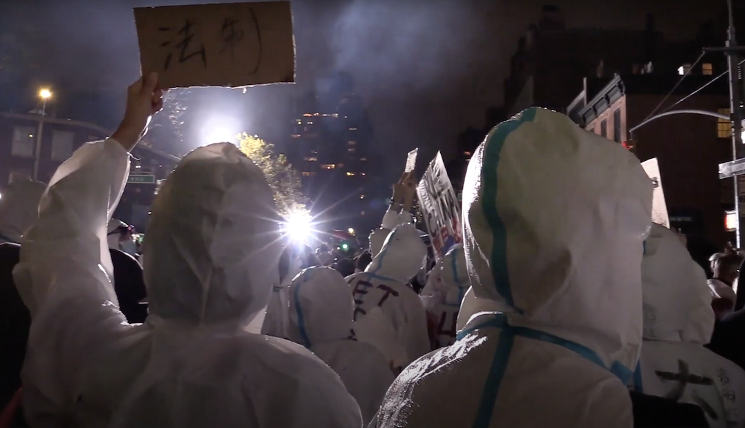 Chinese protesters holding signs