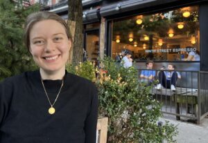 Author Emi Nietfeld poses in front of the facade of Ninth Street Espresso