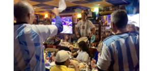A crowd of Argentinian world cup fans in a restaurant in Corona, Queens