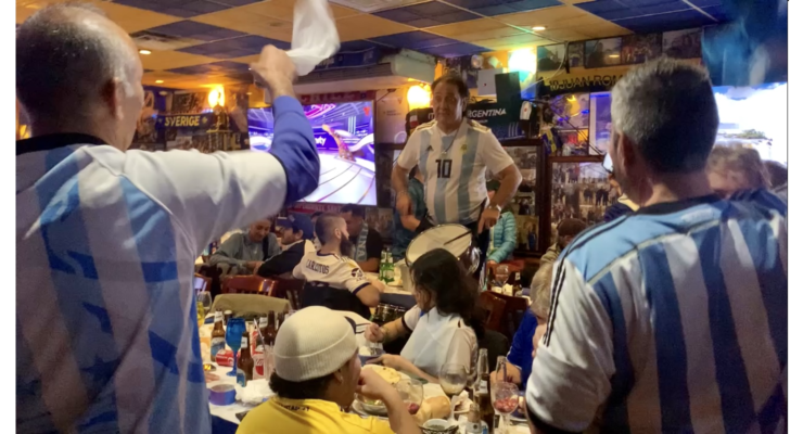 A crowd of Argentinian world cup fans in a restaurant in Corona, Queens
