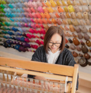 Yukako weaving on the loom