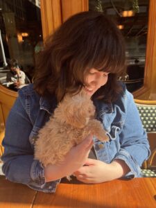 Emma Donelly-Higgins holds her puppy, Sybil, at a restaurant in New York