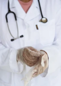 Doctor with stethoscope preparing for surgery in hospital.