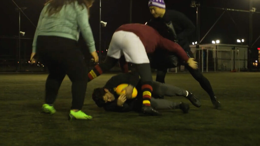 Four people playing rugby