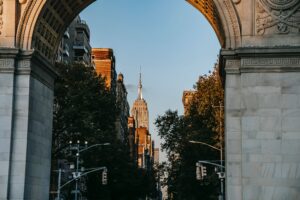 Building through the archway on Washington Square Park North on a sunny day.