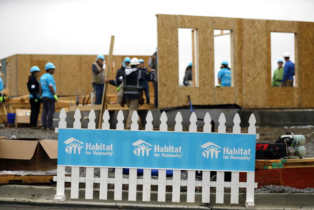 Volunteers work at a Habitat for Humanity building project