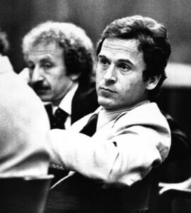 Accused murderer Theodore Bundy leans back in his chair and examines the various members of the media present in the courtroom in Tallahassee, Fla., April 26, 1979.