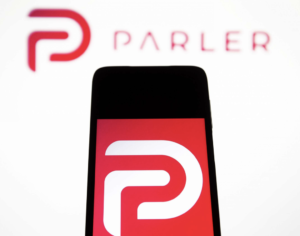 A cell phone displaying a red logo for with a capital white letter "P" in the center