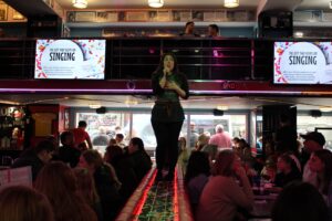 Brodman singing at Ellen’s Stardust Diner