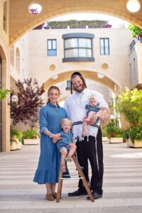 Leah Levine, COO of Ezras Nashim, with her husband and two young children.