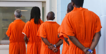 Prisoners line up to vote at the D.C. Jail in Washington. The voters at this southeast Washington polling place were all dressed alike: orange jumpsuit, white shoes. And when they finished voting they went back to their cell block, not back to work. Still, voting inside the D.C. Jail looked a lot like voting at precincts around the country (AP Photo/Jacquelyn Martin)