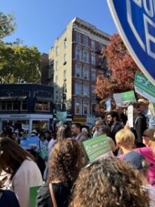 Attendees hold yes on Prop. 1 signs and gather around Manhattan elected officials